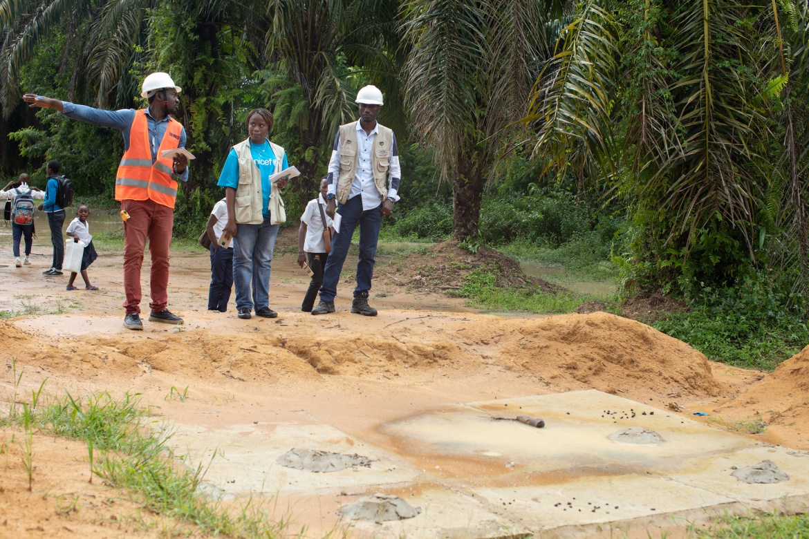 Local education officials and UNICEF representatives (acting as GPE grant agent) survey a school site in Maniema province after the rain.